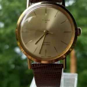 Vintage 1964 Timex 21 jewel self wind waterproof Men's gold tone dress watch.  | WatchCharts