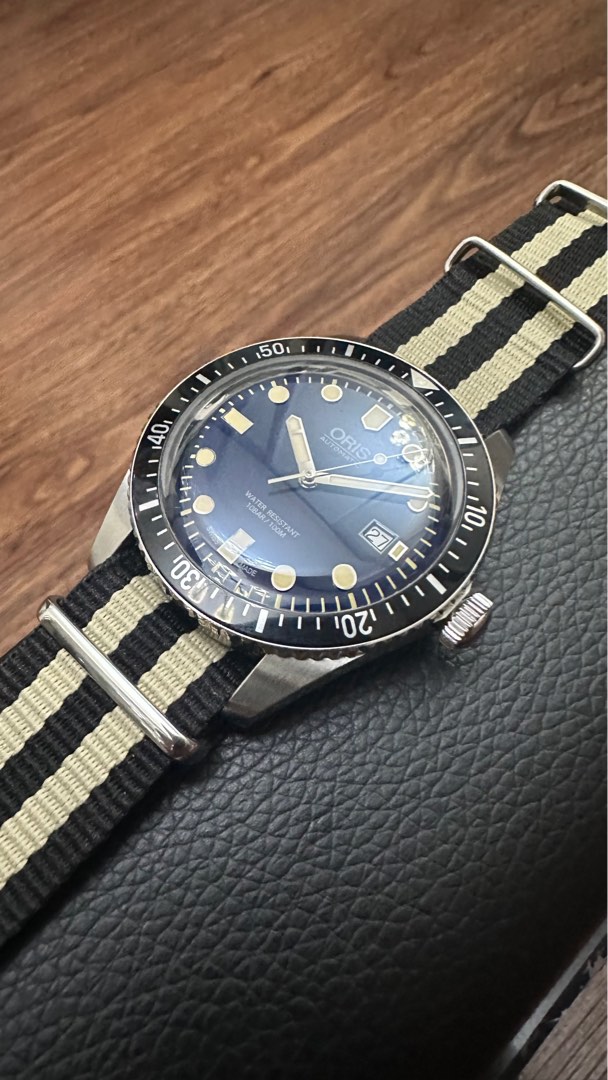 Cheapest Oris Diver 65 in Teal Sunburst Blue on Nato WatchCharts